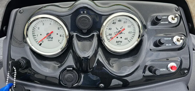 Slide: The Image of Dashboard of 2025 Tracker Super Guide V-16 SC with RPM and MPH gauges. - 7