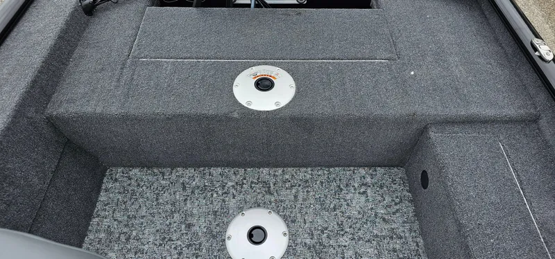 Slide: The Image of Interior of 2025 Tracker Super Guide V-16 SC boat, featuring carpeted flooring and seat mounts. - 9