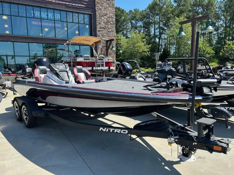 The Image of 2025 Nitro Z20 XL Pro boat displayed outdoors at a dealership. - 0