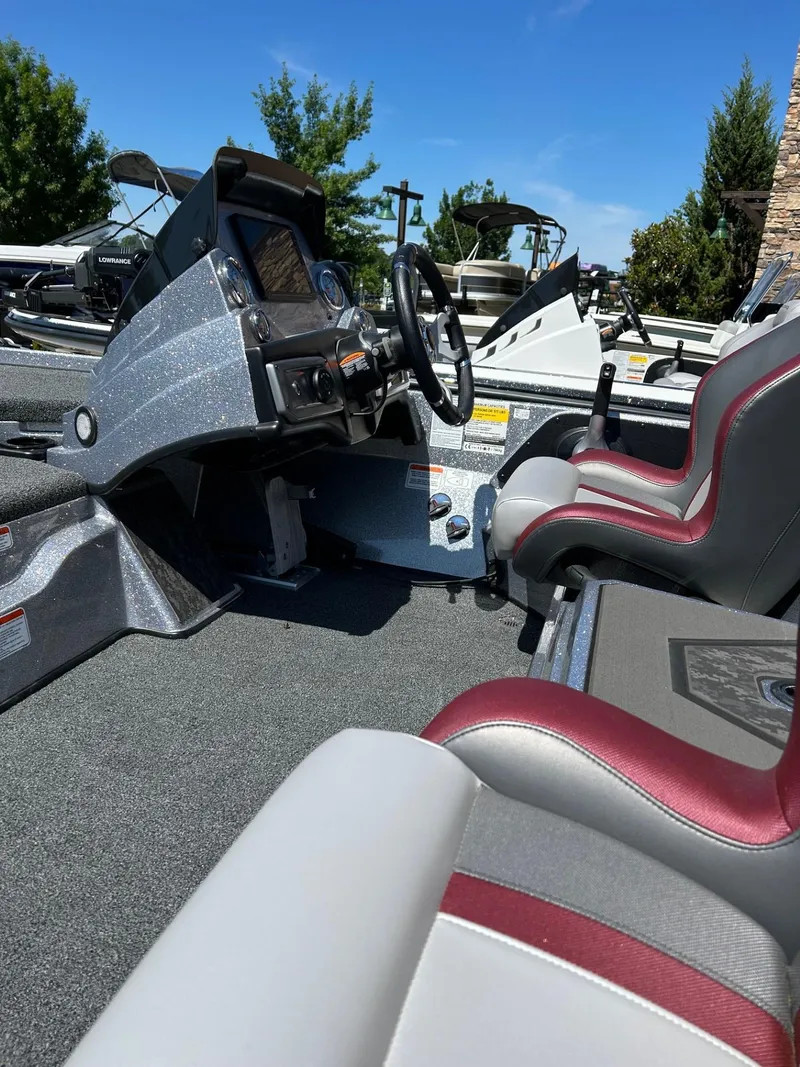 Slide: The Image of 2025 Nitro Z20 XL Pro boat interior with steering console and seating. - 2