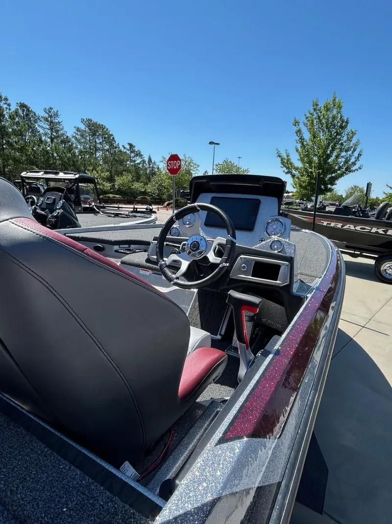 Slide: The Image of 2025 Nitro Z20 XL Pro boat interior with steering wheel, dashboard, and seating under clear blue sky. - 3