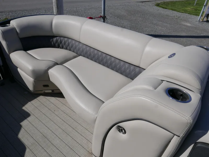 Slide: The Image of 2019 Barletta L23QCSS pontoon boat interior with plush seating and cup holder. - 11