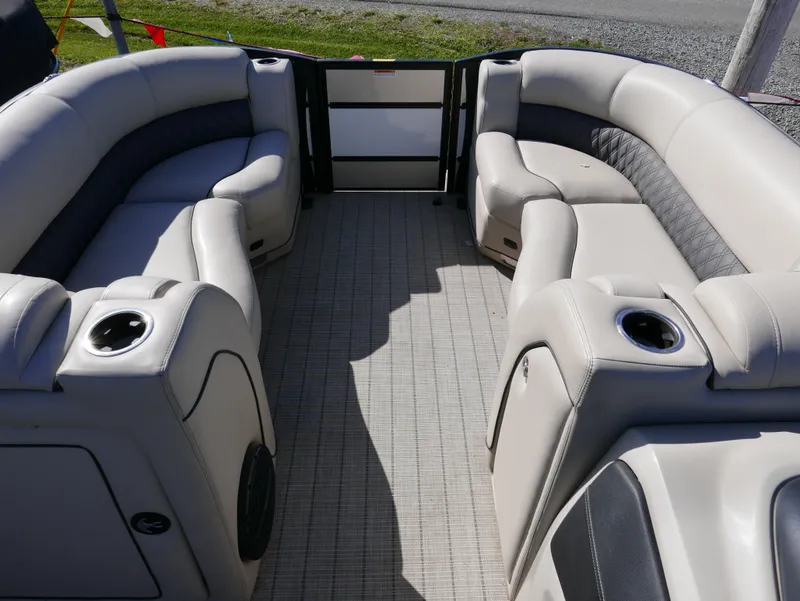 Slide: The Image of 2019 Barletta L23QCSS pontoon boat interior with plush seating and cup holders. - 13