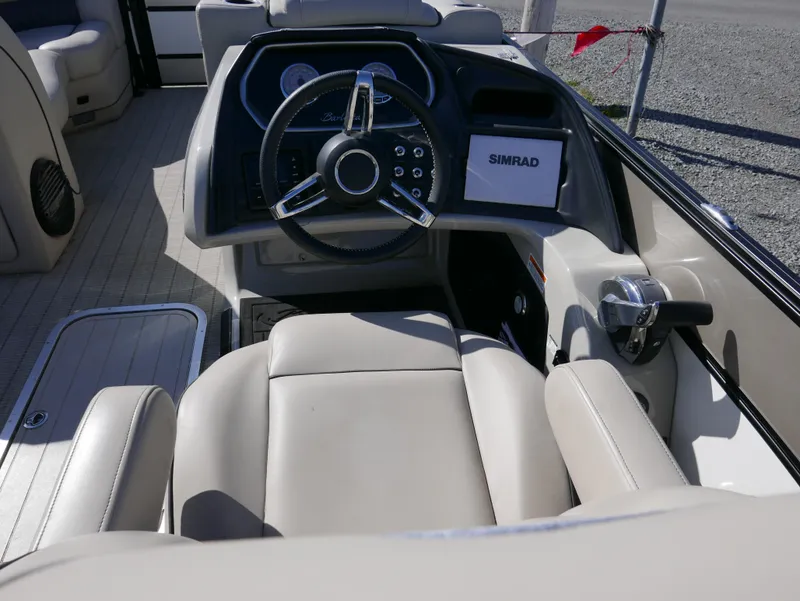 Slide: The Image of 2019 Barletta L23QCSS boat interior with steering wheel and Simrad display. - 16