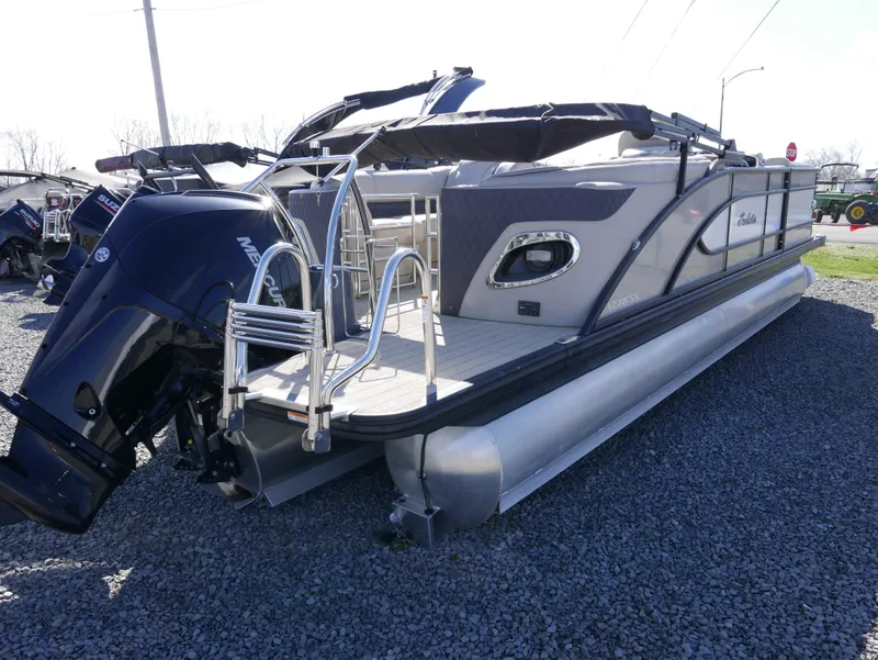 Slide: The Image of 2019 Barletta L23QCSS pontoon boat with outboard motor on gravel lot. - 8