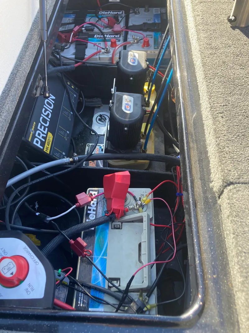 Slide: The Image of 2015 Ranger Z521 Comanche boat battery compartment with multiple batteries and wiring. - 16