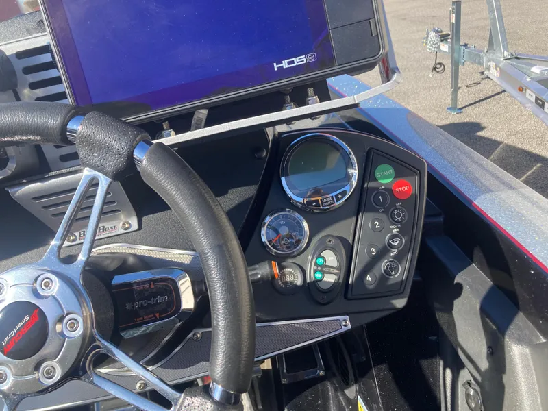 Slide: The Image of 2015 Ranger Z521 Comanche boat dashboard with steering wheel and control panel. - 20