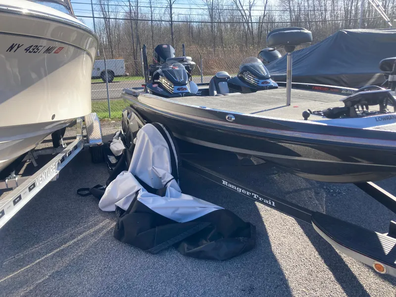 Slide: The Image of 2015 Ranger Z521 Comanche boat parked outdoors, next to another boat, under clear skies. - 26