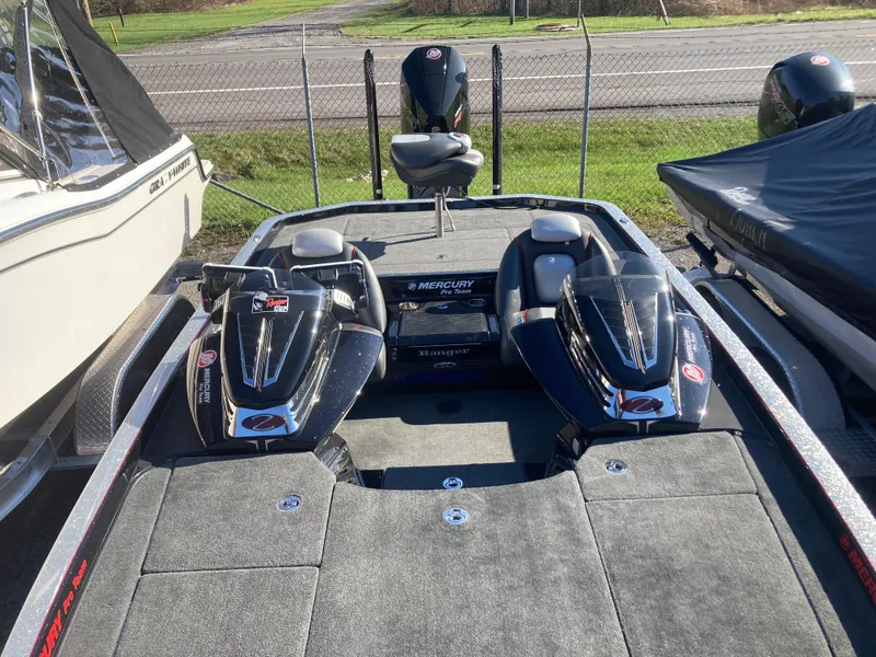 Slide: The Image of 2015 Ranger Z521 Comanche boat with dual Mercury engines, parked outdoors. - 8
