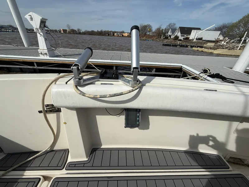 Slide: The Image of 1998 Tiara Yachts 2900 Open boat deck with rod holders and water view. - 12