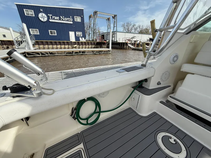 Slide: The Image of 1998 Tiara Yachts 2900 Open boat interior with dockside view, featuring nautical equipment. - 13
