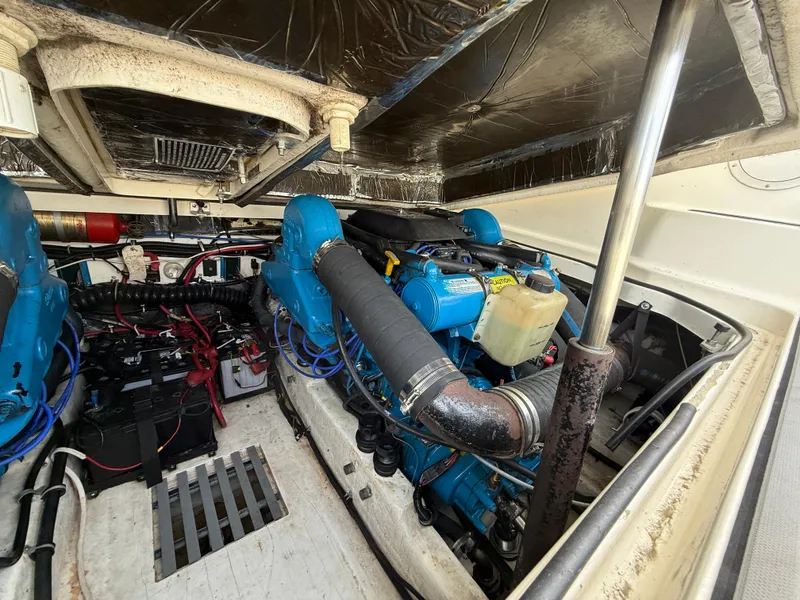 Slide: The Image of Engine compartment of a 1998 Tiara Yachts 2900 Open, showcasing dual blue engines. - 14