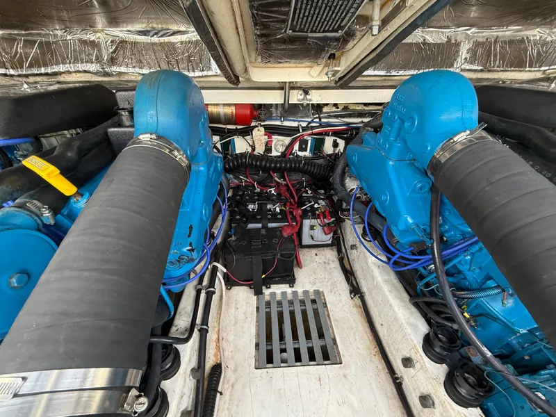 Slide: The Image of Engine compartment of a 1998 Tiara Yachts 2900 Open, featuring dual blue engines. - 16
