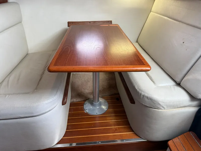 Slide: The Image of Interior seating area of a 1998 Tiara Yachts 2900 Open with wooden table. - 17