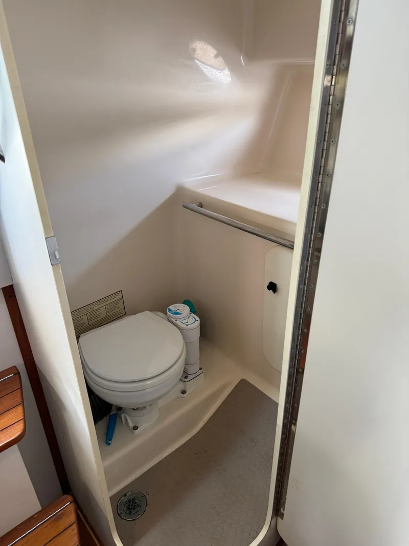 Slide: The Image of 1998 Tiara Yachts 2900 Open bathroom interior with toilet and storage space. - 18