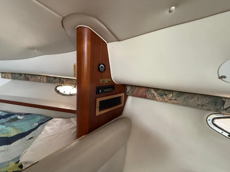 Slide: The Image of 1998 Tiara Yachts 2900 Open cabin interior with wood accents and porthole. - 21