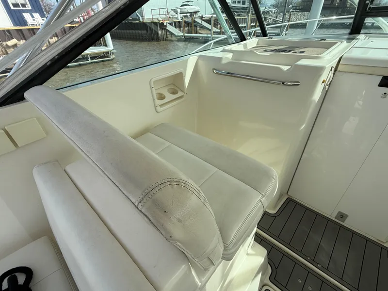 Slide: The Image of 1998 Tiara Yachts 2900 Open cockpit with white seating and control panel. - 4