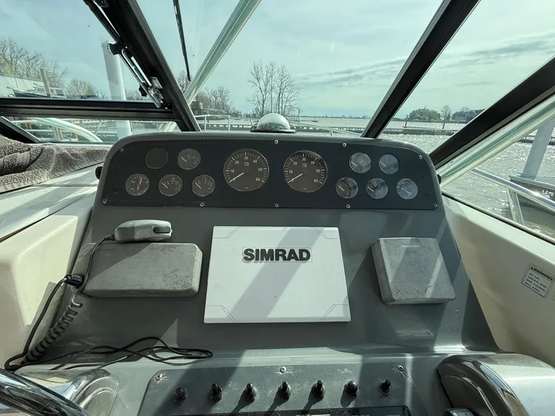 Slide: The Image of 1998 Tiara Yachts 2900 Open helm with Simrad navigation system and gauges. - 5