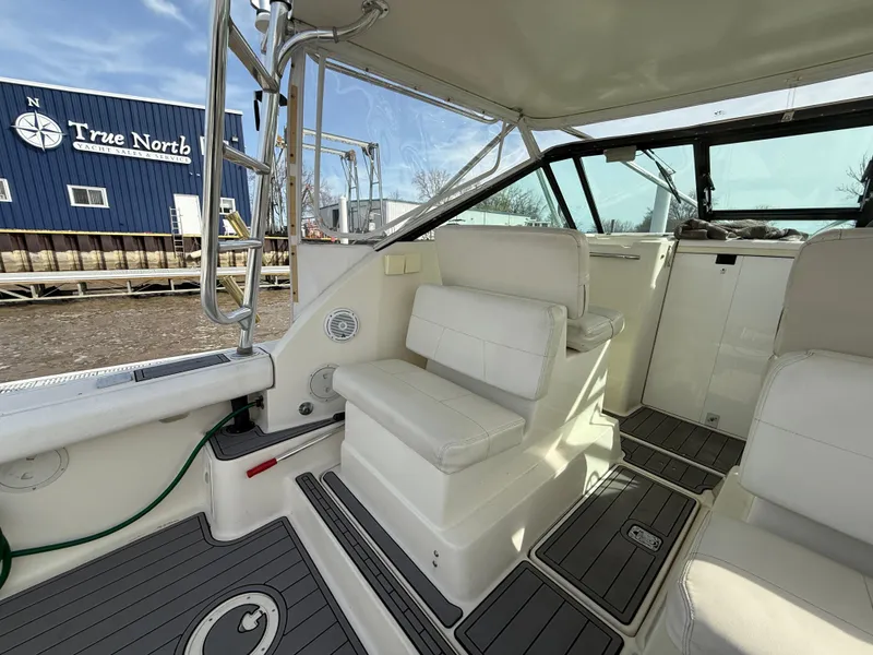 Slide: The Image of 1998 Tiara Yachts 2900 Open interior with white seating and sleek design. - 9
