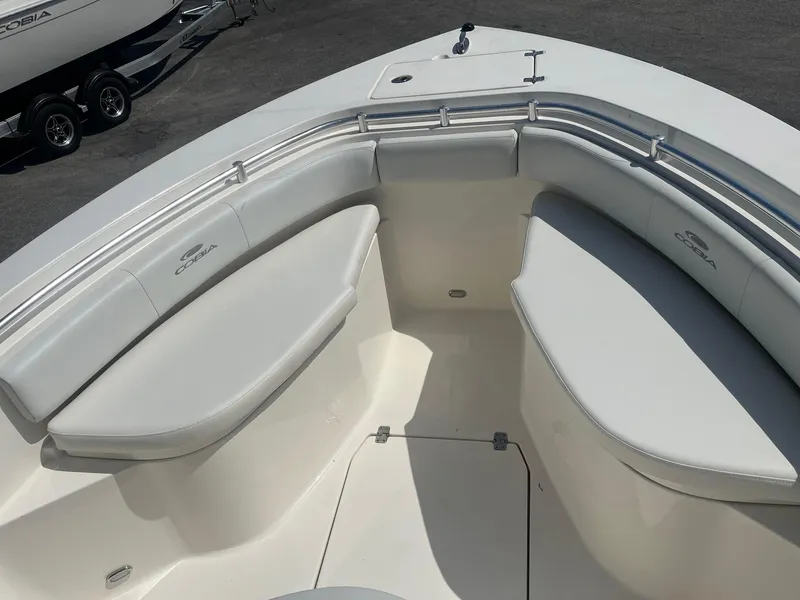 Slide: The Image of 2022 Cobia 237 Center Console boat with cushioned seating in the bow area. - 12