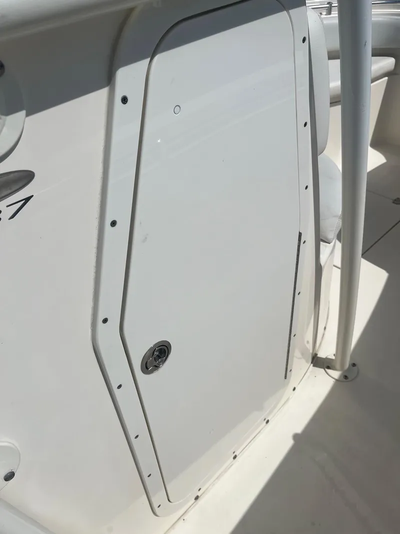 Slide: The Image of 2022 Cobia 237 Center Console boat, white side panel detail. - 13