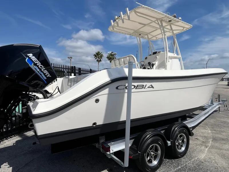 Slide: The Image of 2022 Cobia 237 Center Console boat on trailer, featuring Mercury outboard engine. - 4