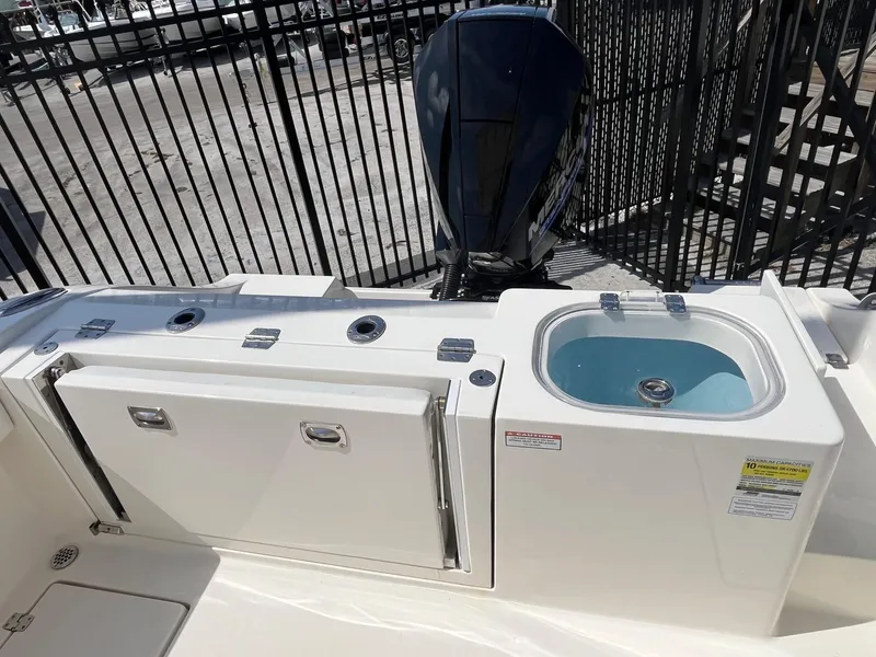 Slide: The Image of 2022 Cobia 237 Center Console boat with livewell and storage compartments. - 9