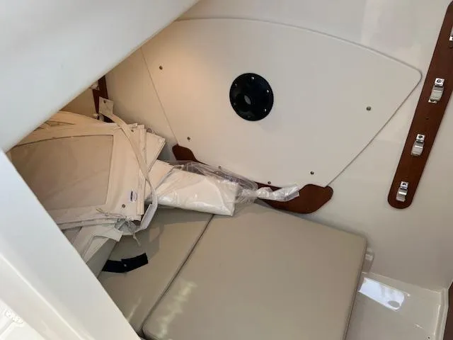 Slide: The Image of 2025 Pursuit DC 326 Dual Console interior cabin with cushions and storage. - 13