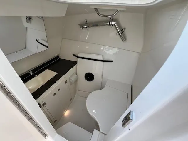 Slide: The Image of 2025 Pursuit DC 326 Dual Console boat interior with modern bathroom amenities. - 14