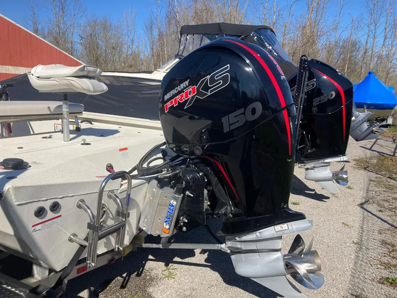 Slide: The Image of 2023 Ranger RB200 boat with dual Mercury Pro XS 150 engines, parked outdoors. - 11