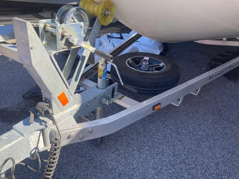 Slide: The Image of Trailer hitch of 2023 Ranger RB200 boat, featuring a sturdy metal frame and spare tire. - 8