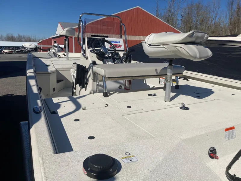 Slide: The Image of 2023 Ranger RB200 boat with seating, steering console, and red building in background. - 9