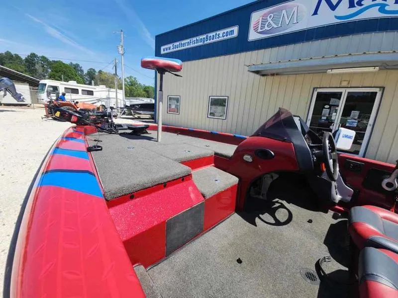 Slide: The Image of 2007 Blazer 190 Pro-V boat with red interior at a marina. - 11