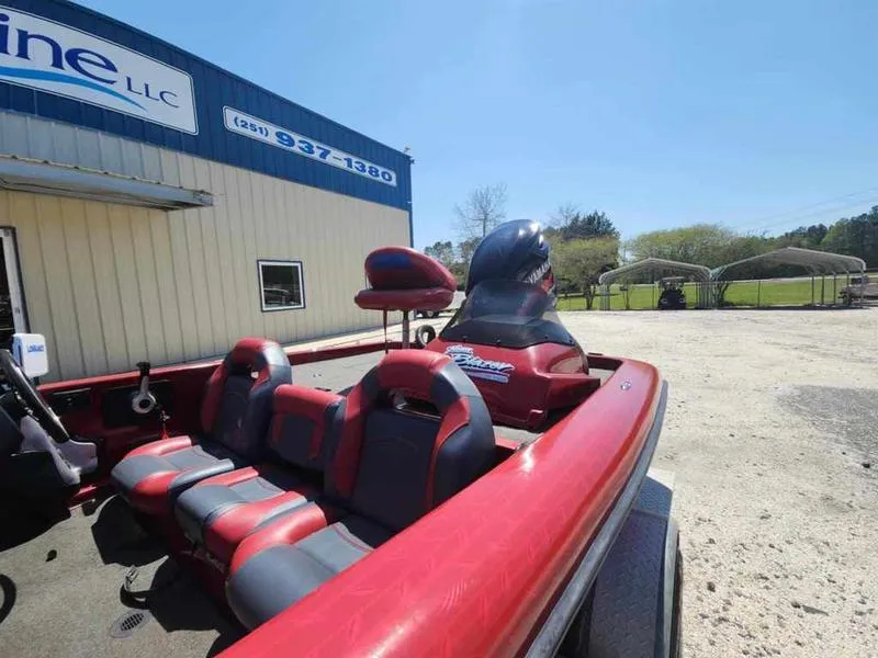 Slide: The Image of 2007 Blazer 190 Pro-V boat with red seats parked outside a building. - 14
