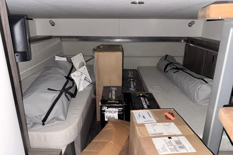Slide: The Image of Interior cabin of 2025 Sea Ray Sundancer 320 with boxes and equipment. - 27