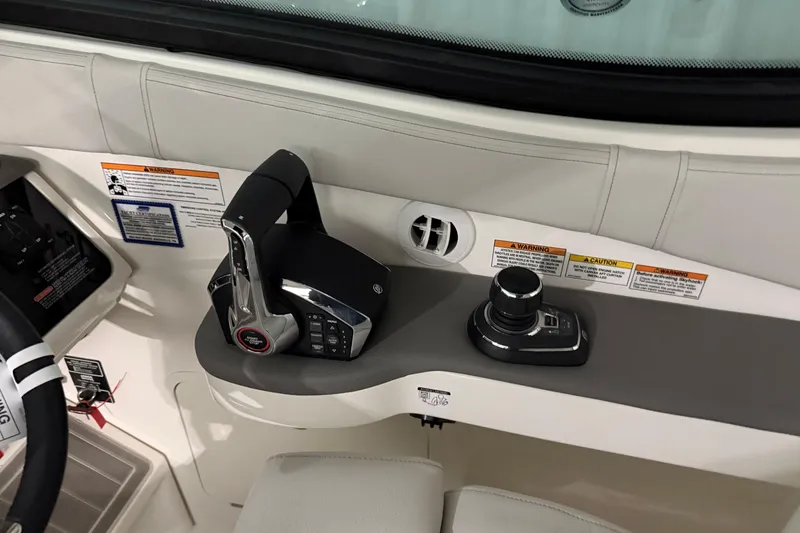 Slide: The Image of Control panel of 2025 Sea Ray Sundancer 320 boat, featuring throttle and joystick controls. - 28