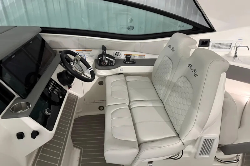 Slide: The Image of 2025 Sea Ray Sundancer 320 helm with dual seats, steering wheel, and control panel. - 40