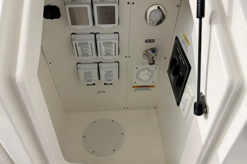 Slide: The Image of Control panel of 2025 Sea Ray Sundancer 320 boat, featuring switches and water access. - 43