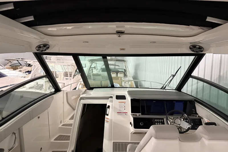 Slide: The Image of Interior view of 2025 Sea Ray Sundancer 320 yacht cockpit with modern controls. - 44
