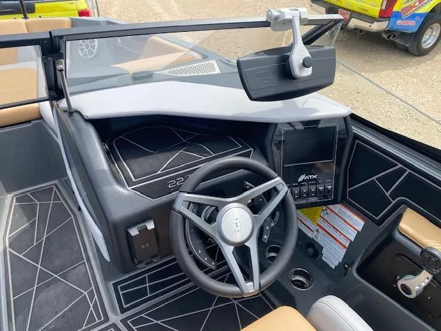 Slide: The Image of 2022 ATX Surf Boats 22 Type-S dashboard with steering wheel and control panel. - 4