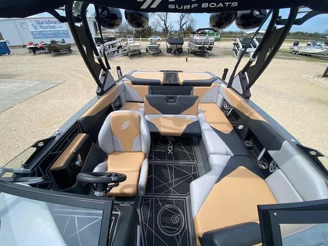 Slide: The Image of 2022 ATX Surf Boats 22 Type-S interior with tan and gray seating, modern design. - 5