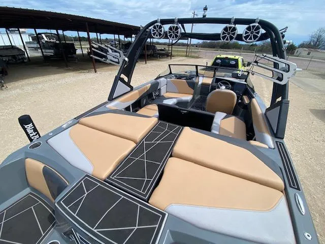 Slide: The Image of 2022 ATX Surf Boats 22 Type-S with tan and black interior, docked outdoors. - 6