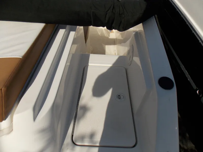 Slide: The Image of 2021 Bayliner VR5 Bowrider OB boat interior with storage compartment and seating area. - 12