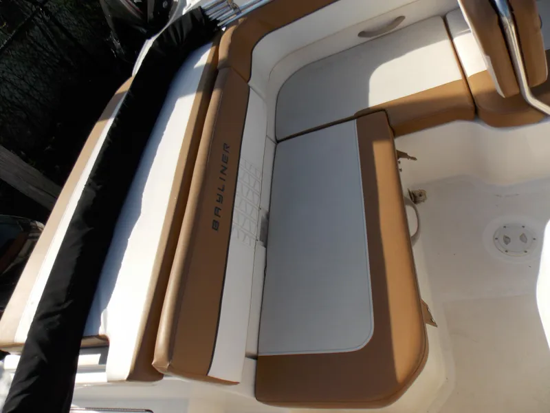 Slide: The Image of 2021 Bayliner VR5 Bowrider OB boat interior with tan and white seating. - 13