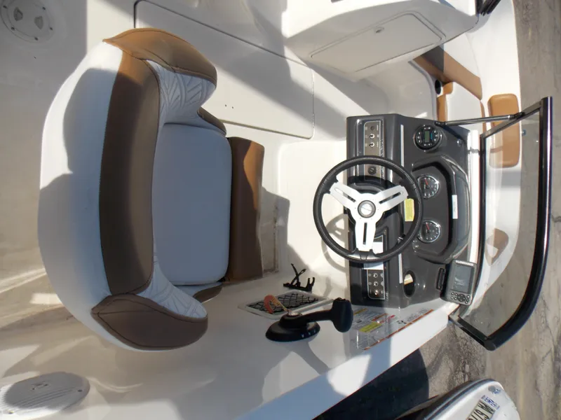 Slide: The Image of 2021 Bayliner VR5 Bowrider OB cockpit with steering wheel and seating area. - 16