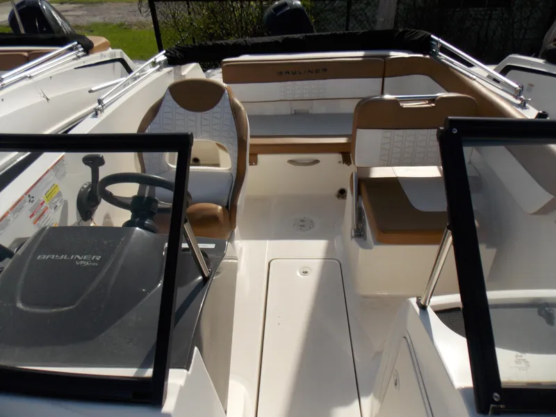 Slide: The Image of 2021 Bayliner VR5 Bowrider OB interior with tan seating and steering console. - 19