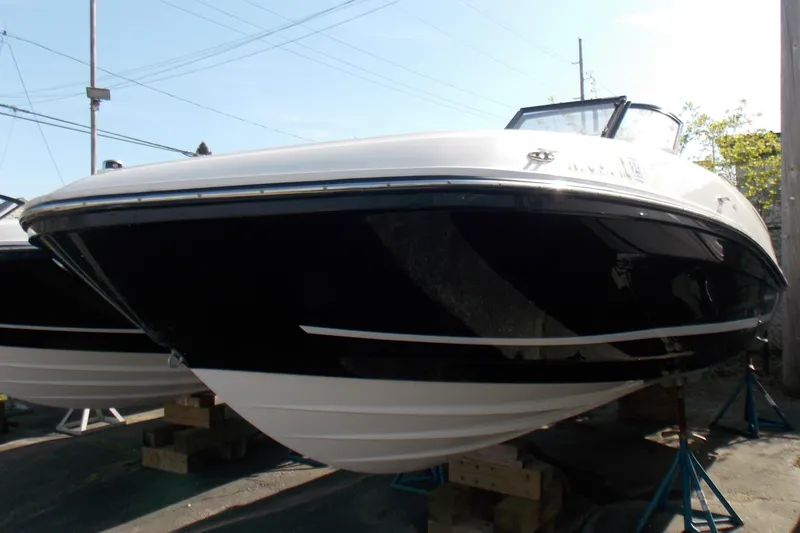 Slide: The Image of 2021 Bayliner VR5 Bowrider OB boat on display, black and white hull, outdoor setting. - 3