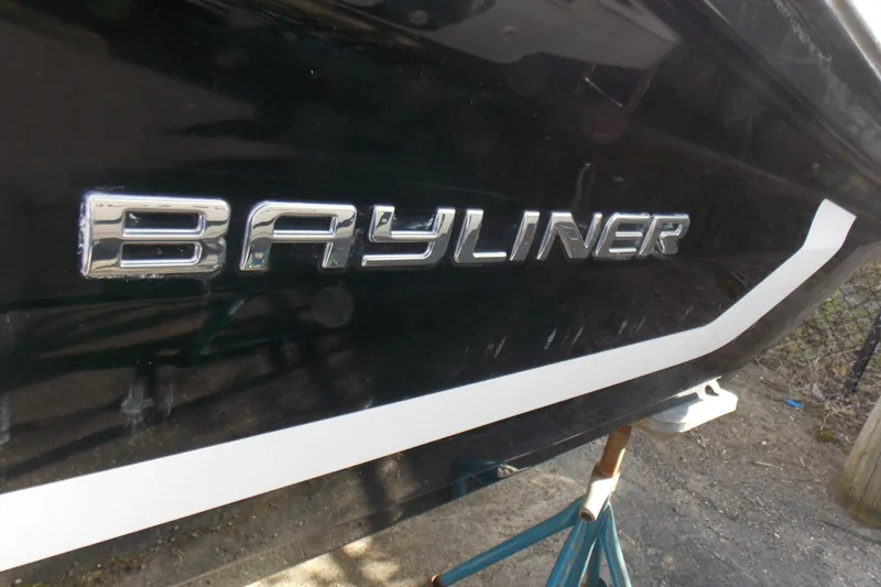 Slide: The Image of 2021 Bayliner VR5 Bowrider OB boat with sleek black exterior and bold logo. - 4