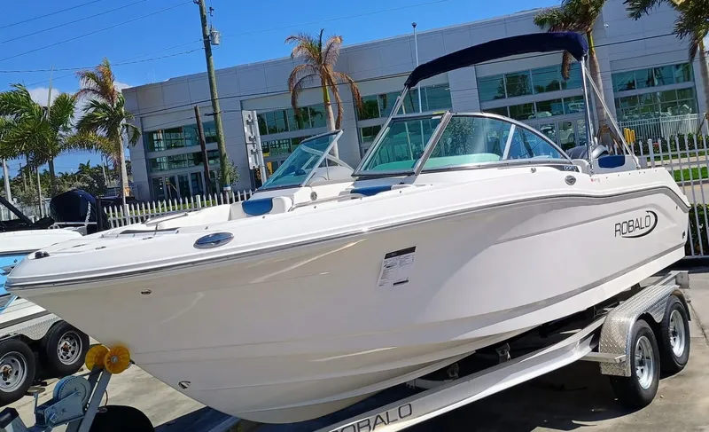 Slide: The Image of 2024 Robalo R207 Dual Console boat on trailer, displayed outdoors. - 0