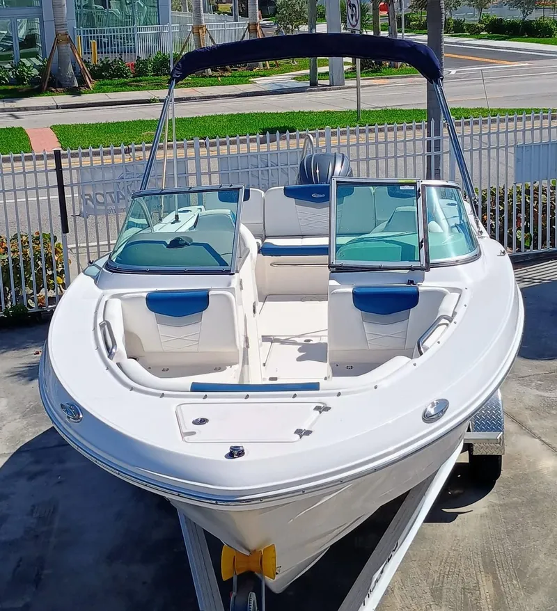 Slide: The Image of 2024 Robalo R207 Dual Console boat on trailer, parked outdoors. - 3